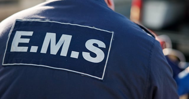 A person wearing a blue jacket with the letters 'MS' on the back.